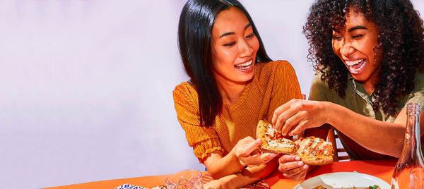 Couple eating Banza pizza