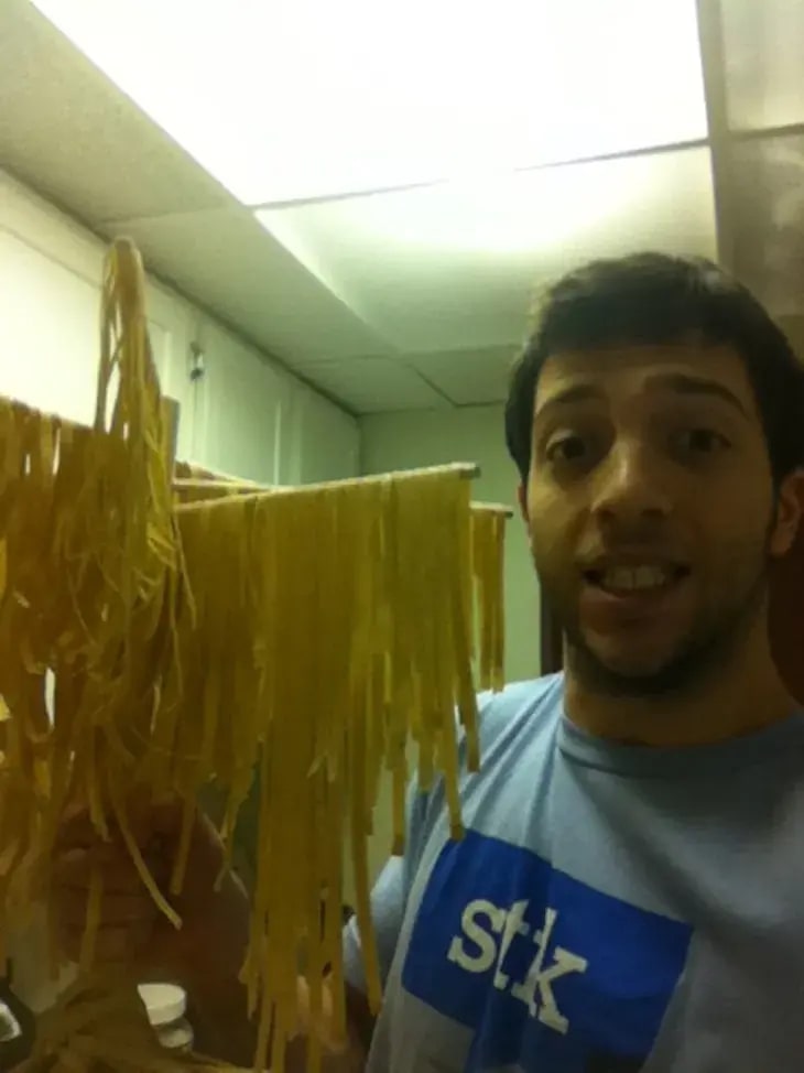 Co-founder Brian Rudolph posing with prototype chickpea pasta hung to dry