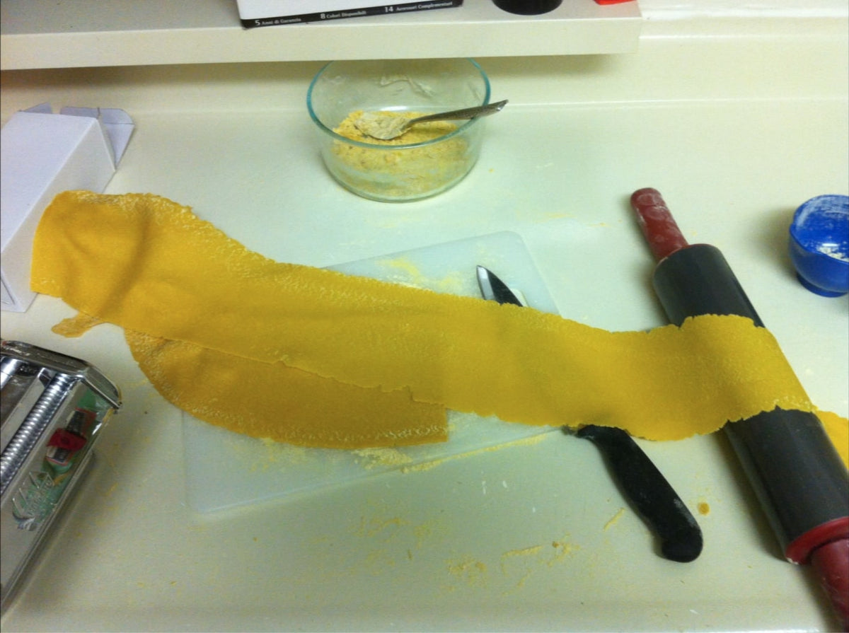 Chickpea pasta rolled out on kitchen counter